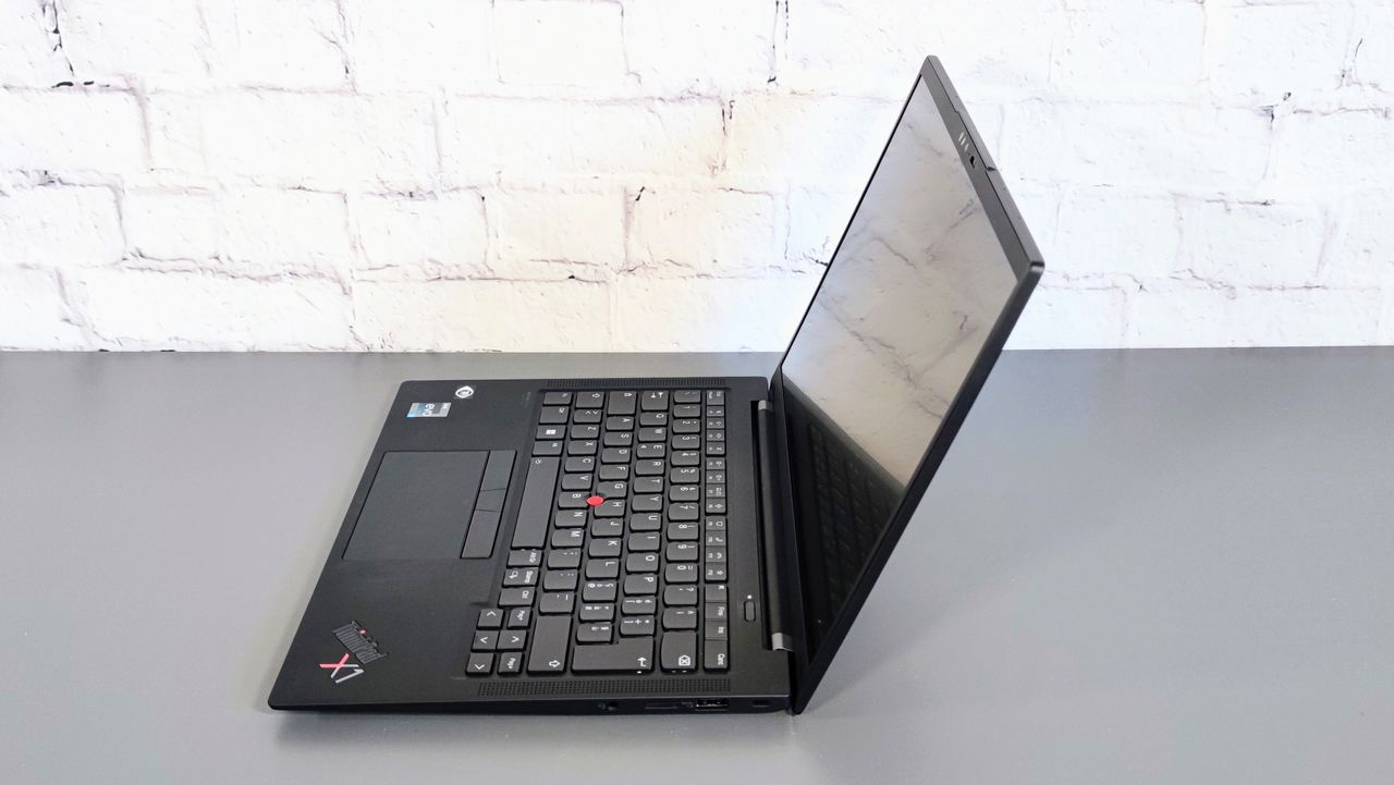 A side-on photograph of the Lenovo ThinkPad X1 Carbon Gen 10 on a table