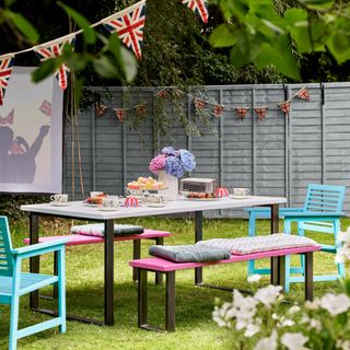 Grey painted garden fence with Jubilee themed garden party