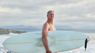 Senior man surfing