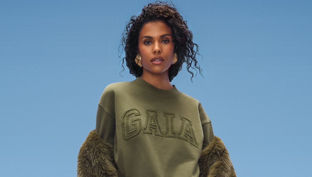 a model wears the gap cult gaia collaboration in front of a plain backdrop