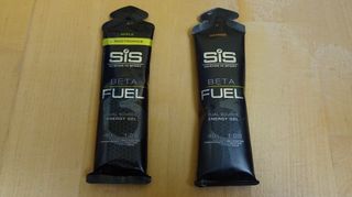 SiS Beta Fuel energy gels for cycling on a wooden table