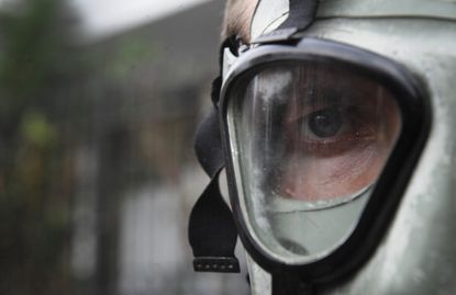 A person wears a gas mask.