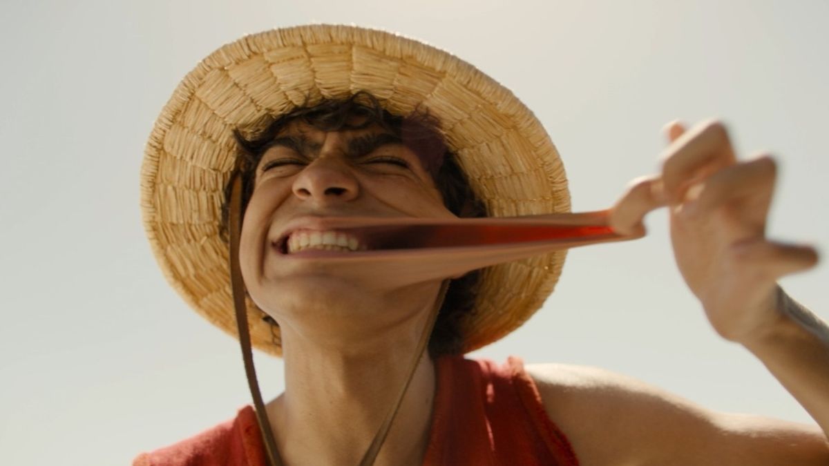 Iñaki Godoy as Monkey D. Luffy stretching his cheek during season one of the Netflix series One Piece. 