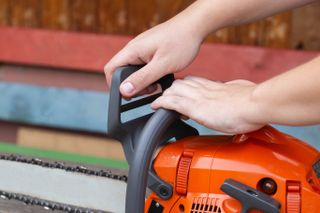 Using the chain brake on a chainsaw