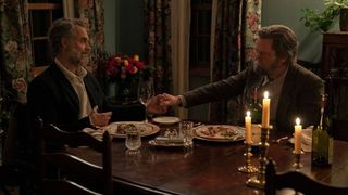 Frank (Murray Bartlett) and Bill (Nick Offerman) holding hands over dinner in The Last Of Us episode 3