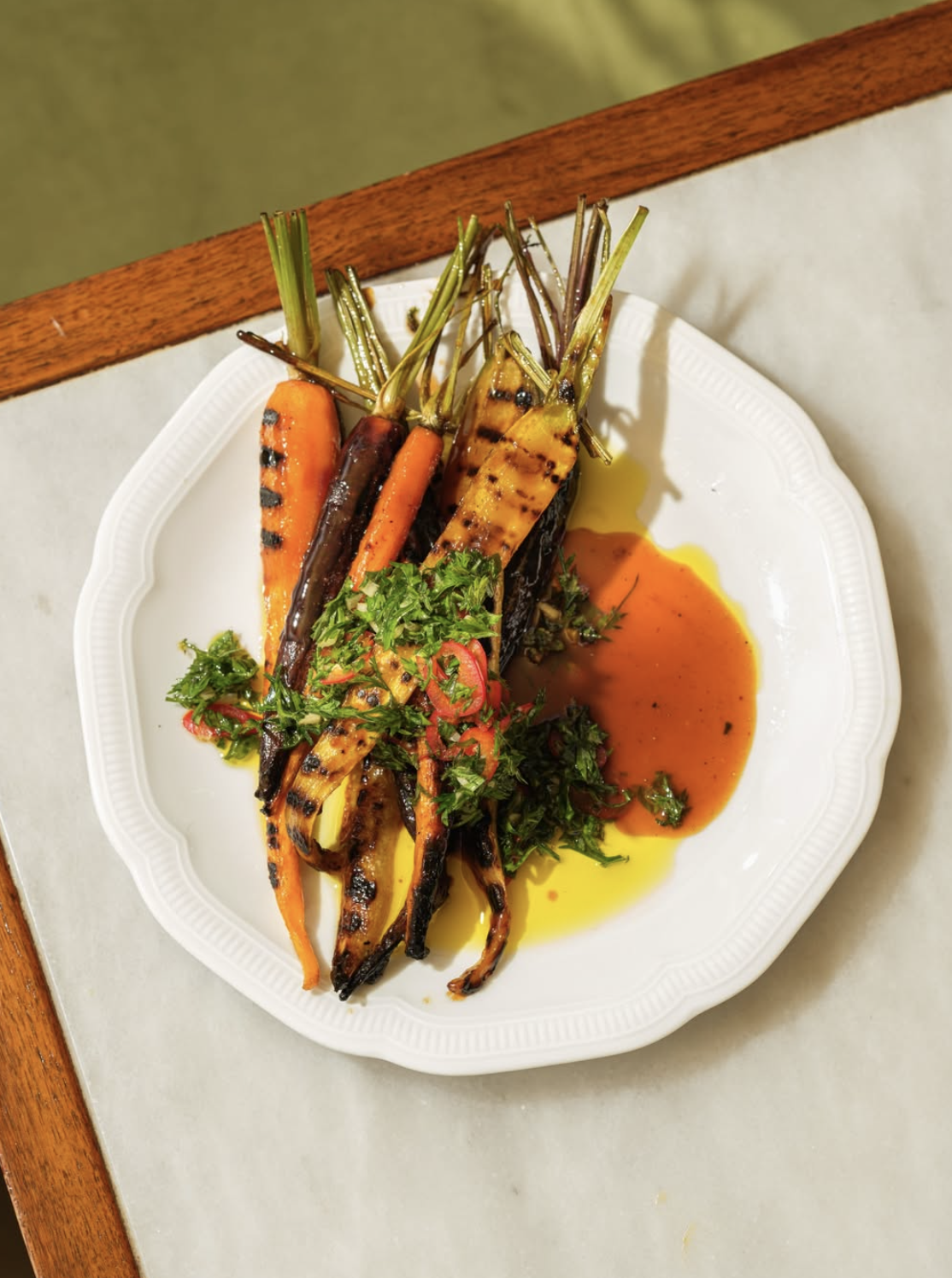 an image of one of the dishes at Tendril Kitchen with different carrot varieties grilled with garnish on top