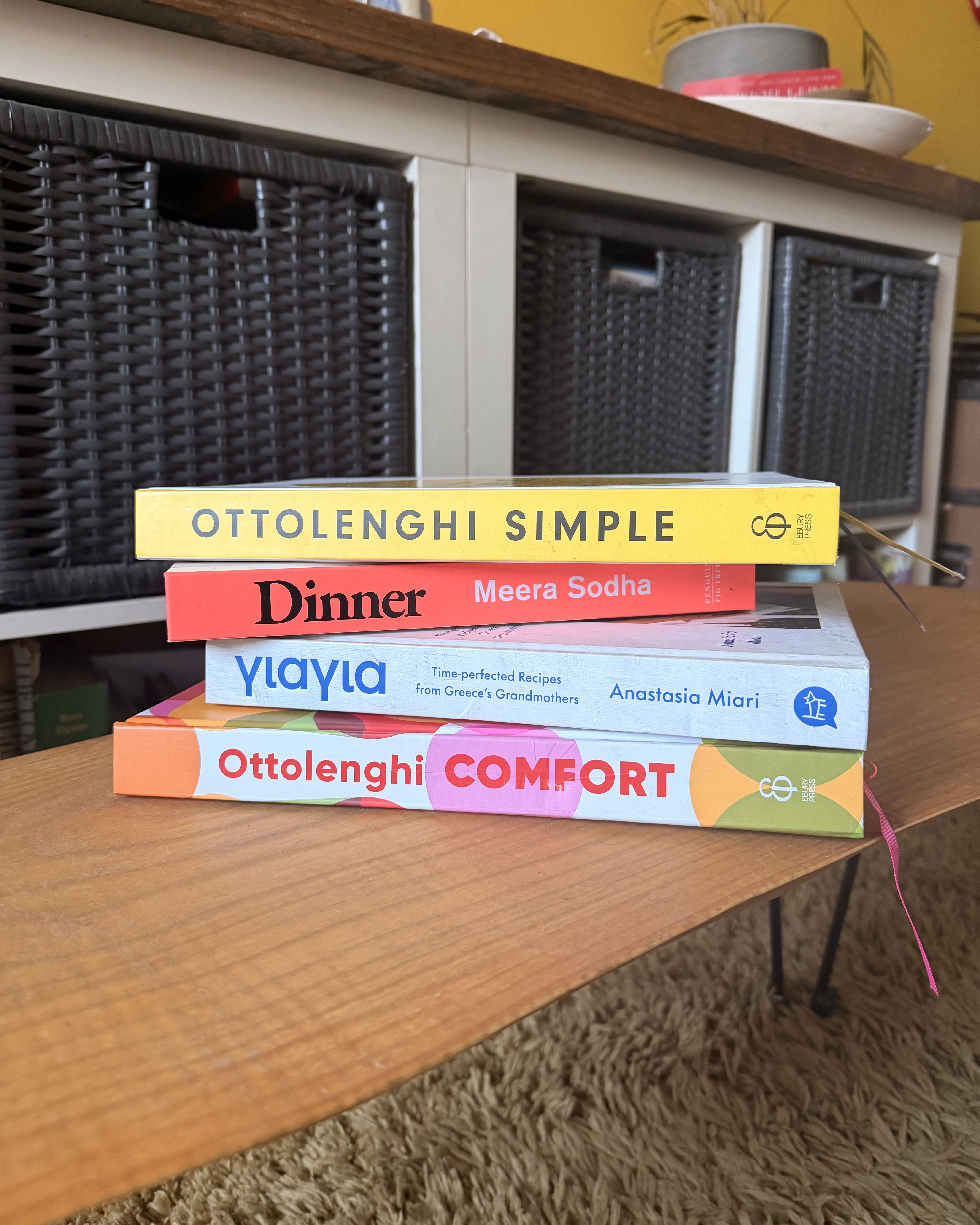 A stack of recipe books on a coffee table