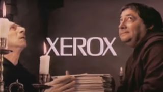 Still from 1970s Xerox ad showing two monks and the Xerox logo