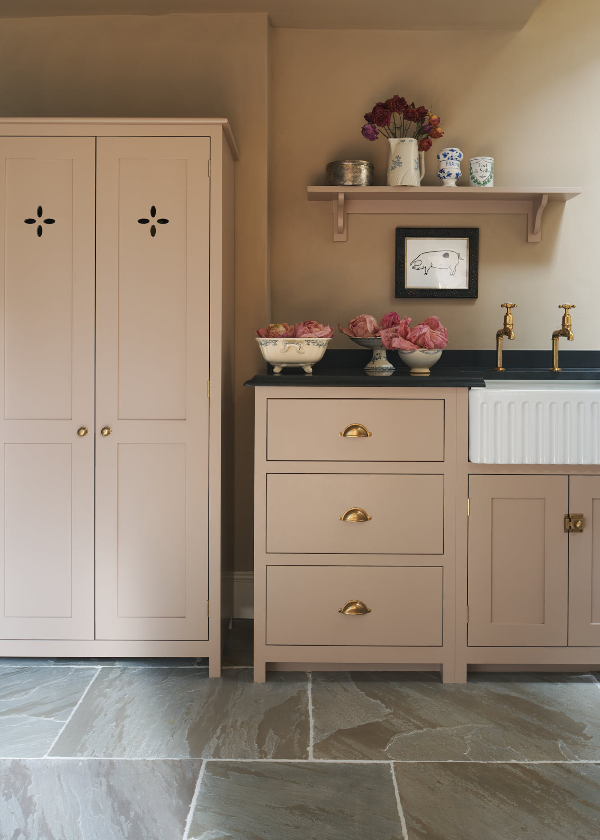 dusty pink cabinets in a shaker kitchen with traditional features