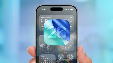 iOS 26 logo on top of the interface of an iPhone