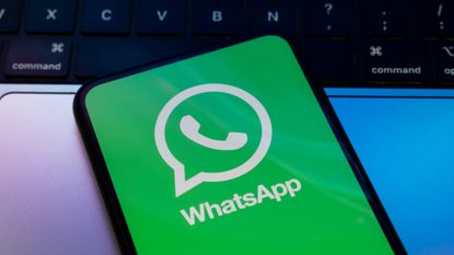 The WhatsApp logo is seen on a phone screen in a file photo.
