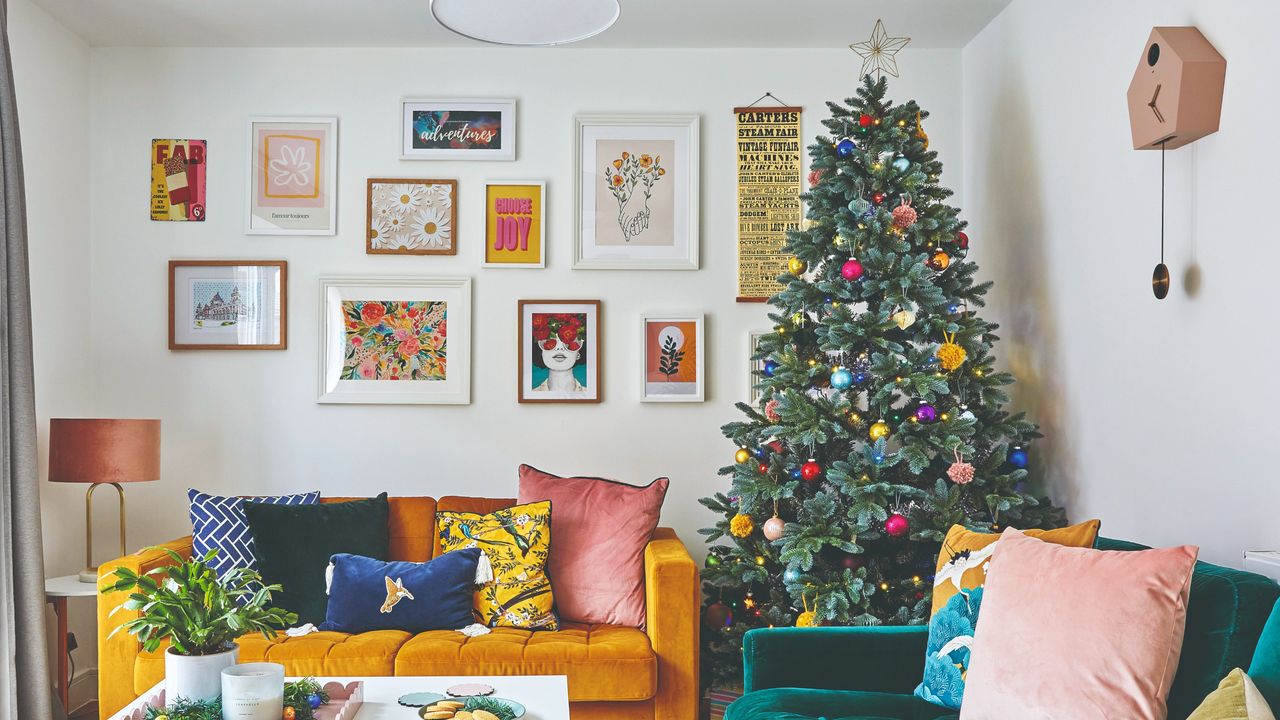 A living room with a green and yellow velvet sofa with a decorated Christmas tree