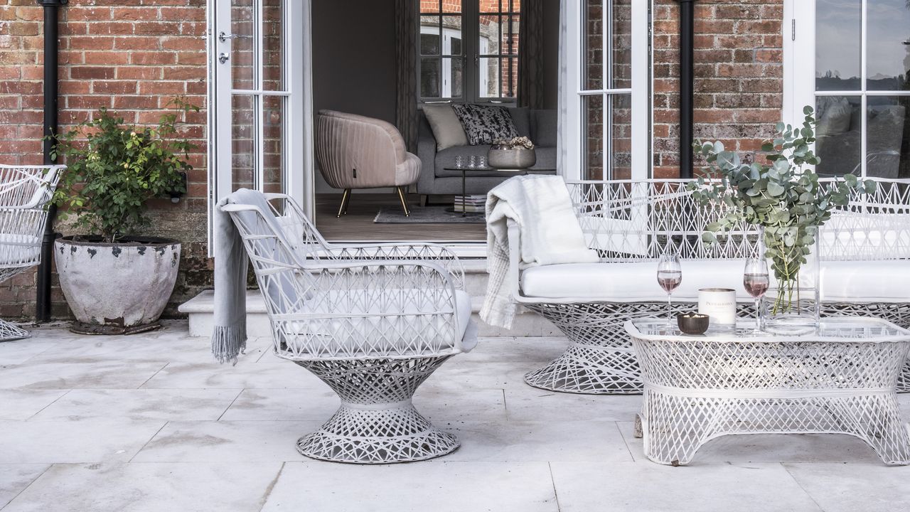 Garden patio area with french doors open to house and table and chairs set.