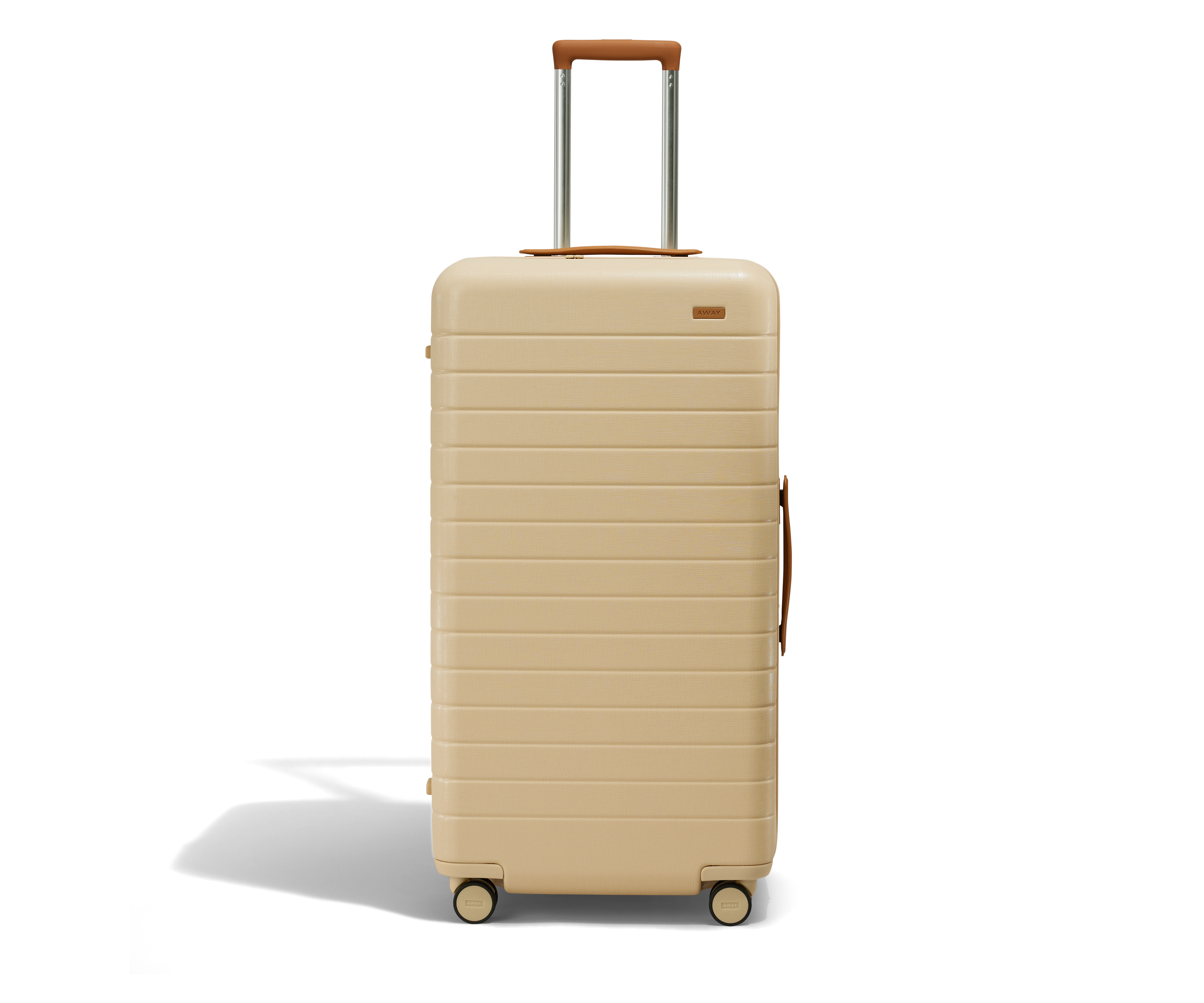 A beige, plastic and leather trunk suitcase.