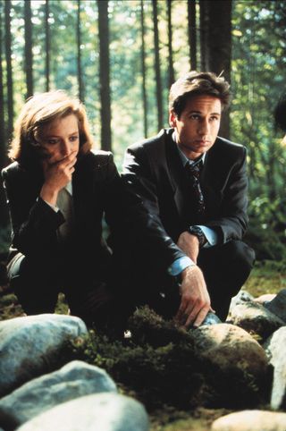 scully and mulder investigating in the woods in 'The X-Files'