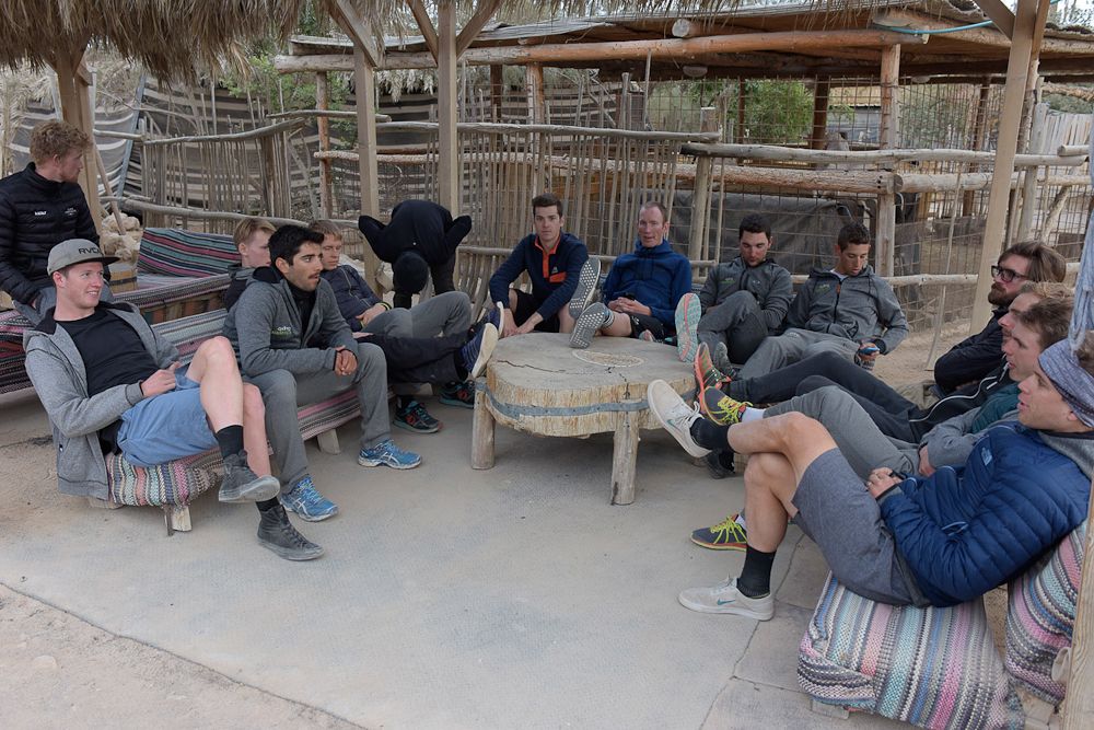 Riders relax in the desert after training.