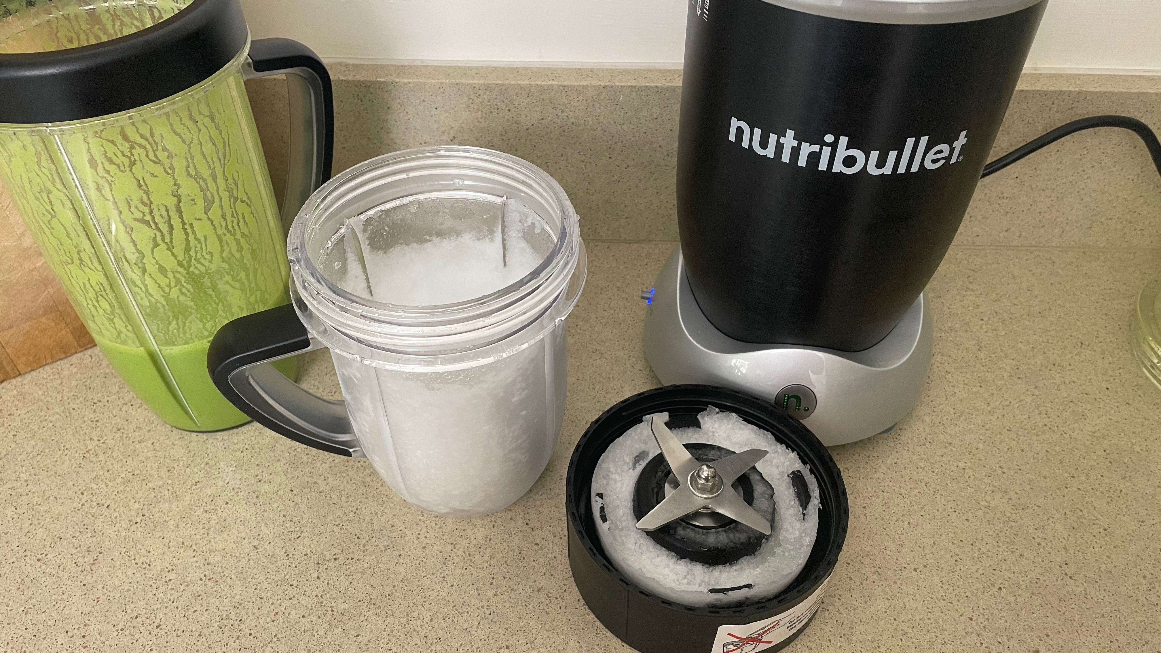 Crushed ice next to the Nutribullet Rx. The ice is mostly finely blended, with some larger chunks