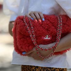 Sonia Lyson wearing a red Chanel bag and a colour manicure