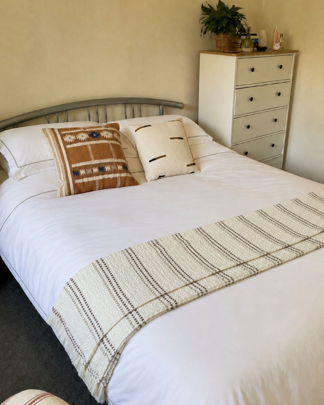 The White Company bedding on bed with throw and cushions