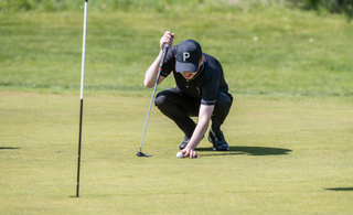 Golfer lines up a putt on the green