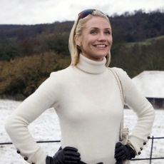 cameron diaz in a white sweater outside of an english cottage in the holiday