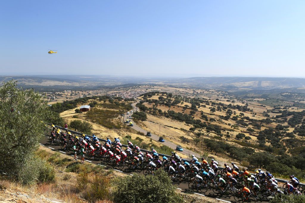PICO VILLUERCAS SPAIN AUGUST 28 A general view of the peloton passing through Alia 583m during the 76th Tour of Spain 2021 Stage 14 a 1657km stage from Don Benito to Pico Villuercas 1580m lavuelta LaVuelta21 on August 28 2021 in Pico Villuercas Spain Photo by Tim de WaeleGetty Images
