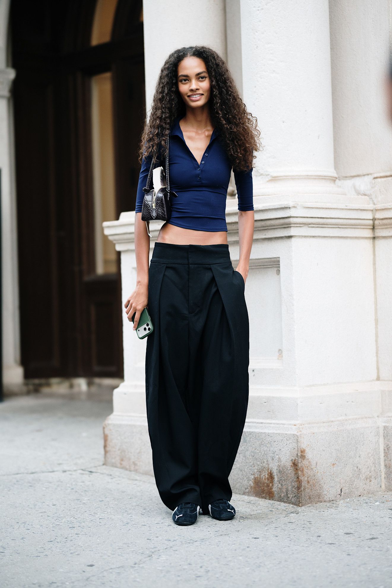 woman wearing a sweater, pants, and flats