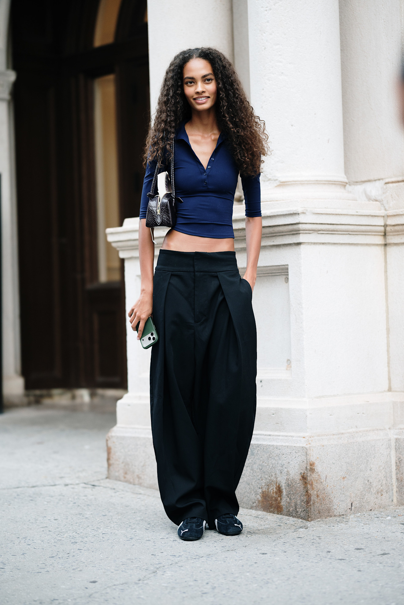 woman wearing a sweater, pants, and flats