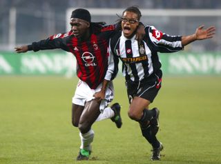 AC Milan's Clarence Seedorf competes for the ball with Netherlands team-mate Edgar Davids during a game against Juventus in 2002.