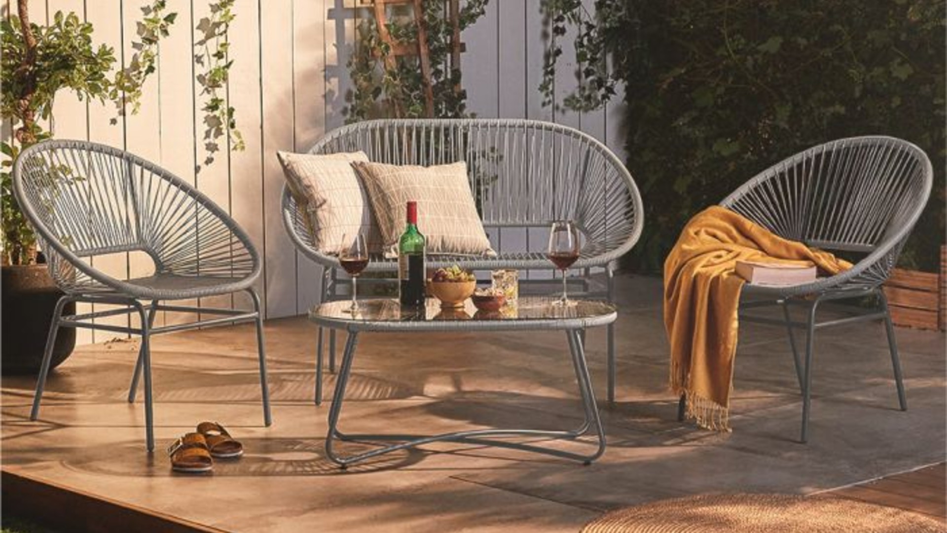 A grey Acapulco outdoor sofa and two chairs