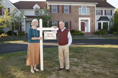 Couple on lawn of house for sale