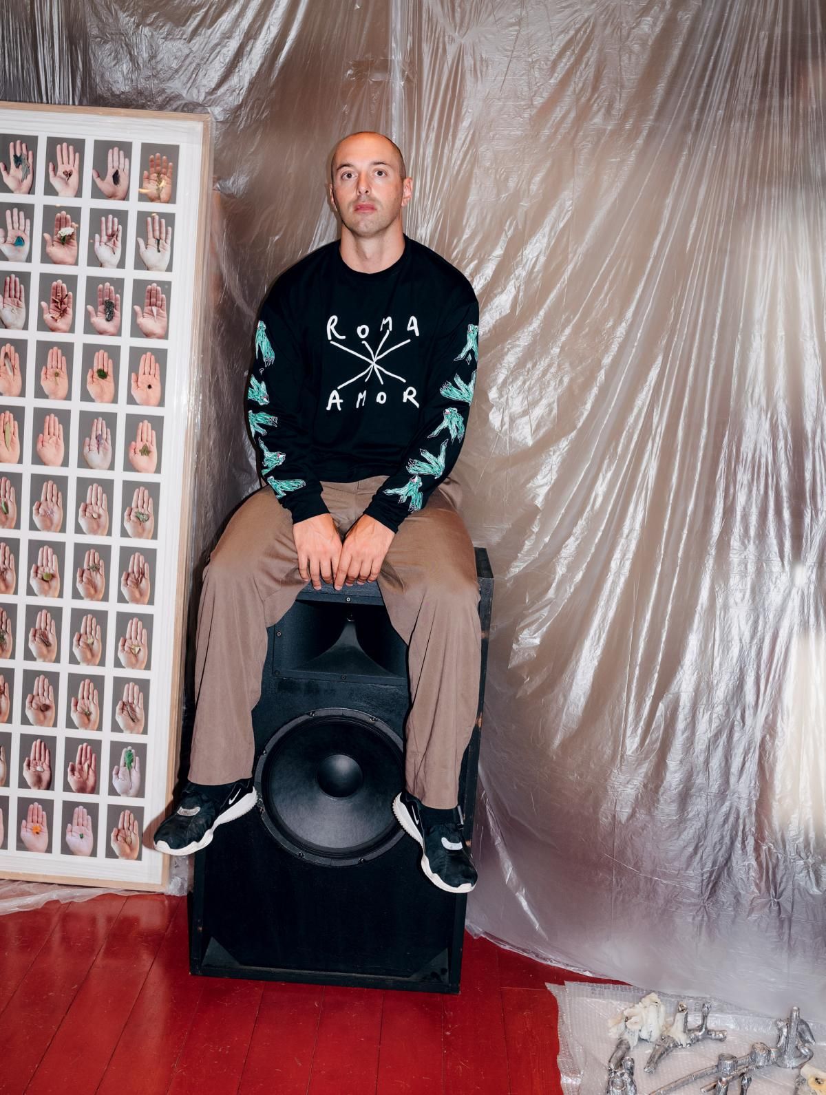 Model sitting on speaker