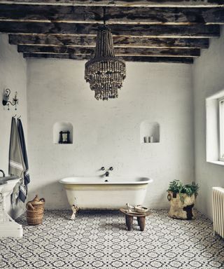 rustic bathroom with wooden beams and distressed metal bath