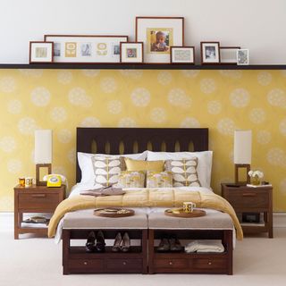 bedroom with yellow wallpaper and picture ledge shelf