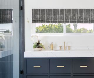 black and white bathroom with orchid next to sink