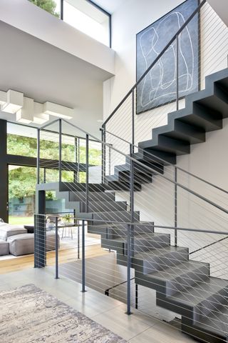 modern staircase over two floors, grey metal, modern living space