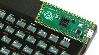 A Raspberry Pi Pico resting on the top edge of a ZX Spectrum