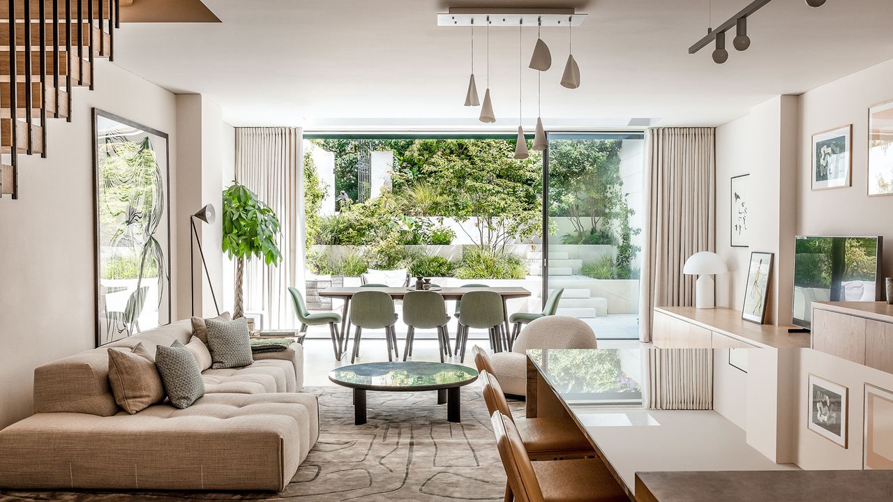  living area with dining table and chairs, modular sofa and green marble coffee table