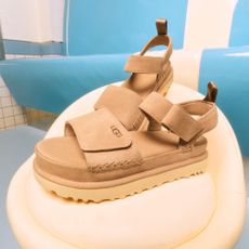 Ugg beige sandals on a white chair