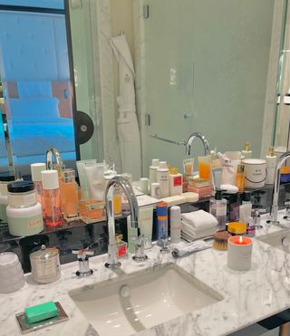 bathroom sink surrounded by skincare