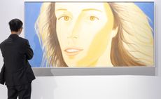 Person views artwork of woman's face at Art Basel Hong Kong 2024