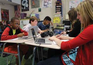 ACSF high-school students using their MacBooks in the classroom.