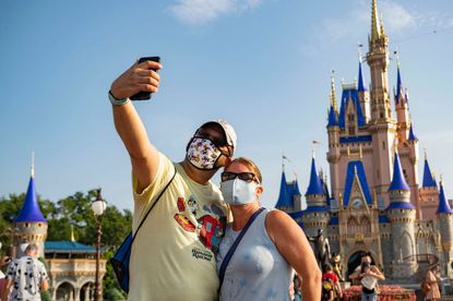 People take a selfie at Disney World.