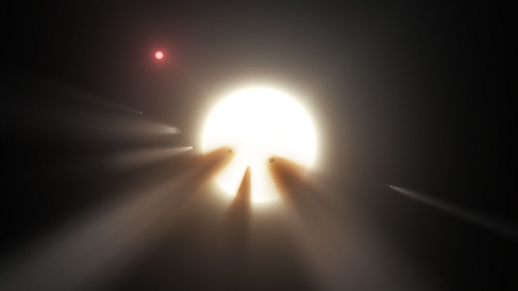 An illustration shows a comet passing in front of a star.