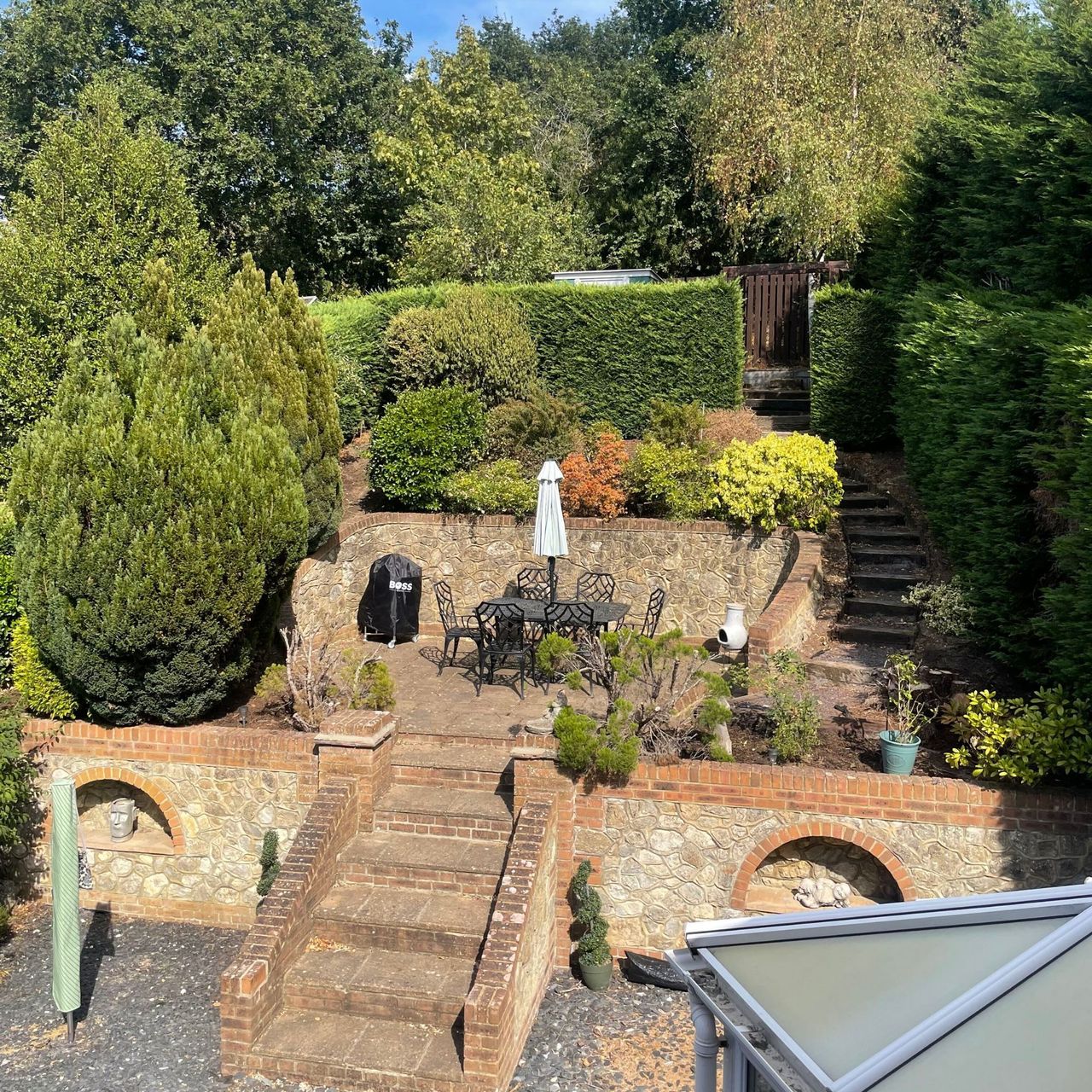 Tuscan-style garden with multiple tiers and lots of shrubs and bushes