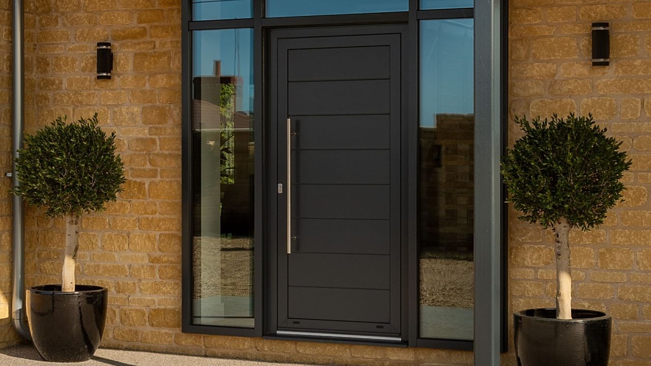 Kloeber aluminium FunkyFront front door with sidelights and two small potted trees either side of the door