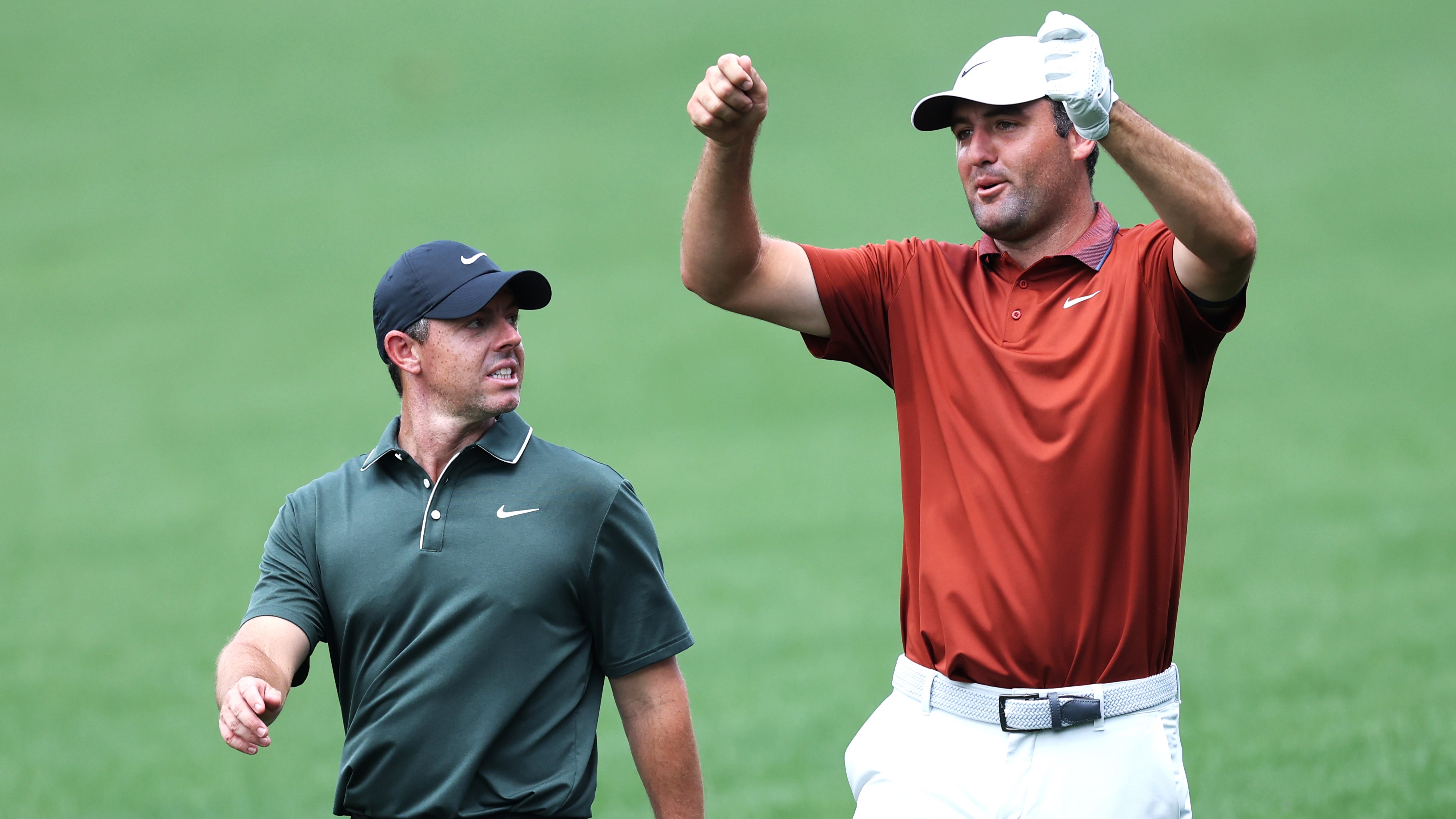 Scottie Scheffler chatting to Rory McIlroy as they walk down a fairway together