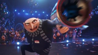 Gru readies a weapon on stage in front of a crowd in Despicable Me 4