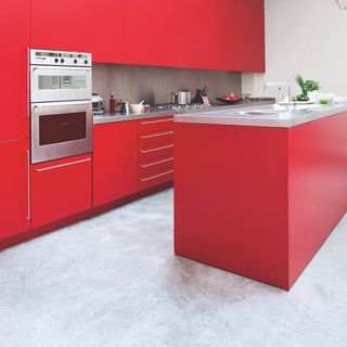 kitchen room with red kitchen cabinets and countertop