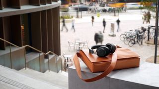 Jabra Elite 85h wireless headphones sat on a satchel